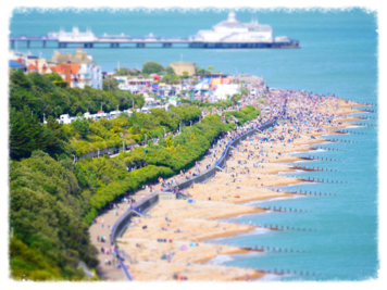 Eastbourne seafront and pier from above on a busy summer day.